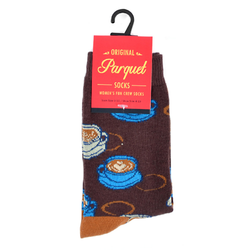A pair of socks designed with playful kittens. bright green yellow, black and white colors.